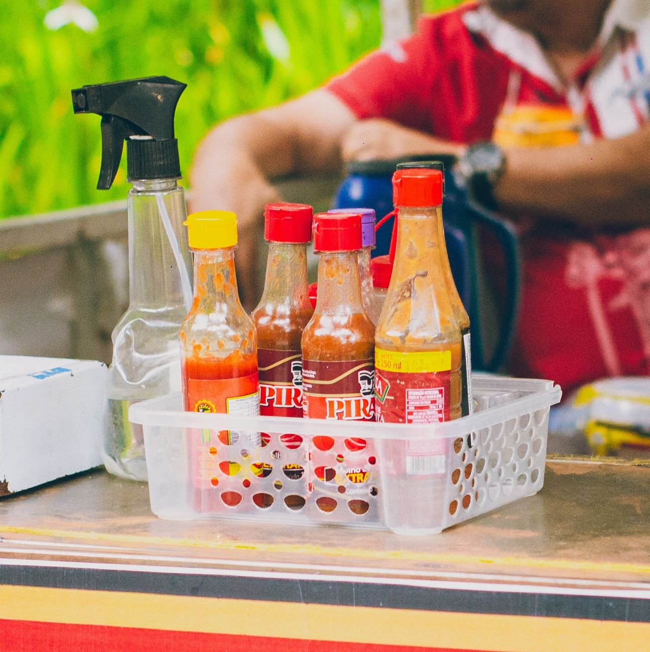 Various hot sauce bottles lined up, showing the full Kin & Fire lineup.